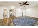 This bedroom features laminate floors, neutral paint, and an open door leading to an ensuite bathroom at 9094 W 103Rd Ave, Broomfield, CO 80021