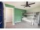 This bedroom features playful green walls, cozy carpeting, and a unique gray bunk bed set at 9094 W 103Rd Ave, Broomfield, CO 80021