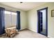 This bedroom features neutral green walls, plush carpeting, and a closet with eye-catching blue trim at 9094 W 103Rd Ave, Broomfield, CO 80021