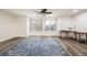 The bright living room features laminate floors, two large windows, and a comfortable desk space at 9094 W 103Rd Ave, Broomfield, CO 80021