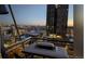 Balcony view of the city with outdoor table and grill covered in snow at 2020 Arapahoe St # 1150, Denver, CO 80205