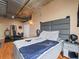 Contemporary bedroom with a large bed, industrial ceilings, and a home gym at 2020 Arapahoe St # 1150, Denver, CO 80205