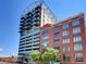 Exterior shot of a modern high-rise featuring a glass facade and steel superstructure at 2020 Arapahoe St # 1150, Denver, CO 80205