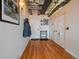 Hallway with light walls, wooden floor, and built-in storage cabinets at 2020 Arapahoe St # 1150, Denver, CO 80205