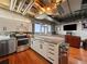 Modern kitchen featuring stainless appliances, white cabinets, tile backsplash, and an open layout to the living area at 2020 Arapahoe St # 1150, Denver, CO 80205