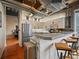 Bright kitchen with stainless steel appliances, sleek cabinets, and industrial-style bar seating at 2020 Arapahoe St # 1150, Denver, CO 80205