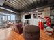 Living area featuring a large couch, exposed pipes, and sports memorabilia at 2020 Arapahoe St # 1150, Denver, CO 80205