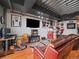 Living room featuring sports memorabilia, leather seating and hardwood floors at 2020 Arapahoe St # 1150, Denver, CO 80205