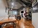Open concept living area with hardwood floors, exposed pipes and city view at 2020 Arapahoe St # 1150, Denver, CO 80205