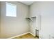 Simple laundry room with built-in shelving and tile floor at 720 Tubman Dr, Elizabeth, CO 80107