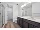Bathroom featuring a double sink vanity, walk-in closet and glass enclosed shower at 6625 N Nepal St, Aurora, CO 80019