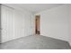 Bedroom with closet and doorway, featuring plush gray carpeting at 6625 N Nepal St, Aurora, CO 80019