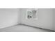 Bright bedroom with neutral carpet, fresh paint, and a large window at 6625 N Nepal St, Aurora, CO 80019