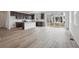 Open kitchen featuring an island, wooden cabinets, stainless steel appliances, and wood floors at 6625 N Nepal St, Aurora, CO 80019