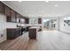Open kitchen featuring an island, wooden cabinets, stainless steel appliances, and wood floors at 6625 N Nepal St, Aurora, CO 80019