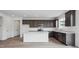 Modern kitchen features dark cabinets, white countertops, and stainless steel appliances at 6625 N Nepal St, Aurora, CO 80019