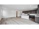 Open-concept living room and kitchen feature hardwood floors and modern stainless steel appliances at 6625 N Nepal St, Aurora, CO 80019