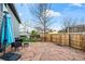 Backyard featuring a stone patio, providing ample space for outdoor seating and entertainment with a wooden privacy fence at 8896 W Teton Cir, Littleton, CO 80128