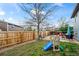 Landscaped backyard featuring a stone patio, wooden fence, and play structure, creating a Gathering-friendly outdoor space at 8896 W Teton Cir, Littleton, CO 80128