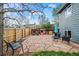 Landscaped backyard featuring a stone patio, wooden fence, playhouse, and charming outdoor seating for relaxation at 8896 W Teton Cir, Littleton, CO 80128