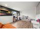 Spacious basement with wood floors, play area, storage and black accent wall at 8896 W Teton Cir, Littleton, CO 80128