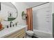 Bathroom with vanity, round mirror, stylish fixtures and shower with tub at 8896 W Teton Cir, Littleton, CO 80128