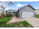 Well-maintained home with lush lawn and landscaping, featuring a two-car garage and welcoming entrance at 8896 W Teton Cir, Littleton, CO 80128