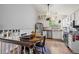 Bright kitchen and dining area featuring a breakfast nook with a round table and staircase to second floor at 8896 W Teton Cir, Littleton, CO 80128