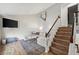 Inviting living room featuring a comfortable couch, staircase to the second floor, and sleek, modern design at 8896 W Teton Cir, Littleton, CO 80128