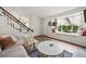 Relaxing living room area with a window seat and open staircase to the second floor and dining area at 8896 W Teton Cir, Littleton, CO 80128