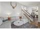 Cozy living room with stylish decor, staircase leading upstairs, and open layout to the dining area at 8896 W Teton Cir, Littleton, CO 80128