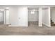 Basement featuring carpeting, white door, and a window at 14441 Maxwell Pl, Denver, CO 80239