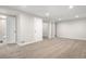 Finished basement with carpet, white door, and support pillars at 14441 Maxwell Pl, Denver, CO 80239