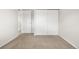 Bedroom with neutral carpet, light colored walls and a closet with sliding doors at 14441 Maxwell Pl, Denver, CO 80239