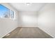 The empty bedroom has neutral paint, carpet floors, baseboard trim, a window, and an air vent at 14441 Maxwell Pl, Denver, CO 80239