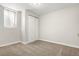 Empty bedroom featuring a neutral carpet, closet with sliding doors and a sunny window at 14441 Maxwell Pl, Denver, CO 80239