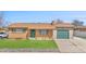 Charming single-story home with a well-maintained lawn, brick facade, and attached garage at 14441 Maxwell Pl, Denver, CO 80239