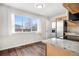 The kitchen has stainless steel appliances, wooden cabinets, granite countertops, and wood-look flooring at 14441 Maxwell Pl, Denver, CO 80239