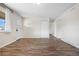 Bright living room with wood flooring, a white front door, and ample natural light at 14441 Maxwell Pl, Denver, CO 80239