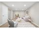 Finished basement living area with carpet, white sofa, and modern decor at 14441 Maxwell Pl, Denver, CO 80239