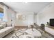 Well-lit living room featuring wood floors, neutral walls, and comfortable seating area. Image virtually staged at 14441 Maxwell Pl, Denver, CO 80239