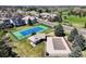 Aerial view of tennis courts, a pool, and a clubhouse in a residential neighborhood on a sunny day at 4373 E Phillips Pl, Centennial, CO 80122