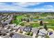 Beautiful aerial view of homes overlooking a golf course with a lake and mountain view at 4373 E Phillips Pl, Centennial, CO 80122