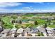Beautiful aerial view of homes overlooking a golf course with a lake and mountain view at 4373 E Phillips Pl, Centennial, CO 80122