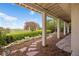Covered patio that looks out onto well manicured landscaping and view of golf course at 4373 E Phillips Pl, Centennial, CO 80122