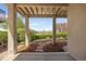 Covered patio that looks out onto well manicured landscaping and view of golf course at 4373 E Phillips Pl, Centennial, CO 80122