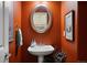 Charming powder room with a pedestal sink and decorative mirror at 4373 E Phillips Pl, Centennial, CO 80122