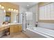 Bright bathroom with a soaking tub, glass enclosed shower, and double sink vanity at 4373 E Phillips Pl, Centennial, CO 80122