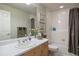 Bathroom with tile walls, a bath/shower combo, and an oak vanity at 4373 E Phillips Pl, Centennial, CO 80122