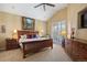 Cozy bedroom with a wooden bed frame, dresser, and a private balcony at 4373 E Phillips Pl, Centennial, CO 80122